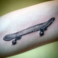 a skateboard tattoo on the right arm