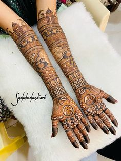 two hands with henna tattoos on them