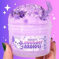 a hand holding a tub of lavender bath soak with purple flakes and sprinkles on it