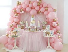 a pink and gold princess themed birthday party with balloons, cake and desserts on the table