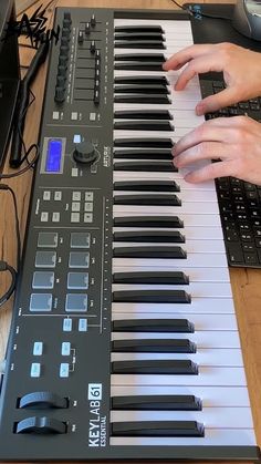 a person playing an electronic keyboard on a desk