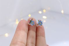 Handmade stud earrings with forget-me-not flowers Made of polymer clay, the flower is not fragile, it has flexible petals. Sold in a gift box. Flower size about 7x7 mm (0.27 inches x 0.27 inches) ❤ flexible petals ❆ not afraid of the cold ☔ not afraid of water All my products you will receive in a gift box! ❀ Please feel free to send me a message if you have any question. Add your valid phone number to the order's note It will be add to the package for better post service Whimsical Blue Flower Earrings For Gift, Delicate Blue Flower Earrings With Ear Wire, Cute Blue Flower Shaped Jewelry, Cute Blue Flower Jewelry, Blue Dainty Hypoallergenic Flower Earrings, Dainty Blue Flower Earrings, Delicate Blue Flower Earrings, Gift Box Flower, Forget Me Not Blue