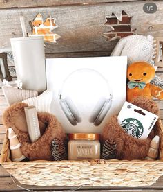 a basket filled with items like headphones, teddy bears and other things in it