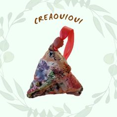 an ornament shaped like a slice of pizza with the word creaouu on it