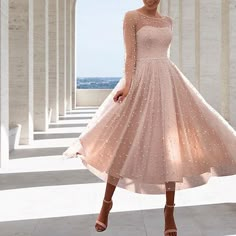 a woman in a pink dress posing for the camera