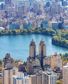 an aerial view of the city and its surrounding lake, with skyscrapers in the foreground