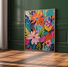 a painting is hanging on the wall in an empty room with wood floors and green walls