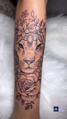 a woman's leg with a lion tattoo on it