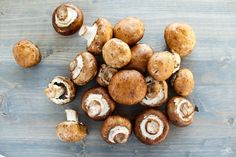 some mushrooms are sitting on a wooden table