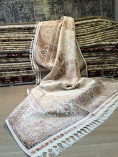 a pile of rugs sitting on top of a wooden floor