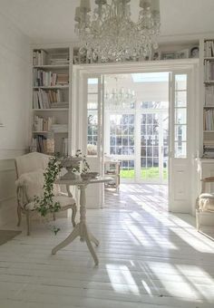 a living room filled with furniture and a chandelier