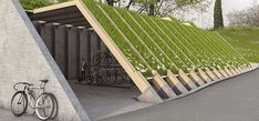 a bike is parked next to a wall with grass growing on it's sides