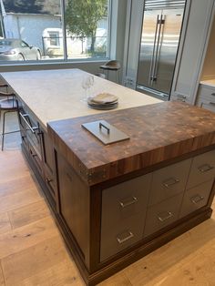 a large kitchen island in the middle of a room with lots of cabinets and drawers