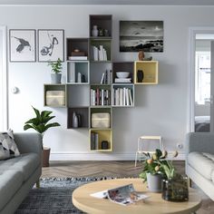 a living room filled with furniture and bookshelves next to a wall mounted book shelf