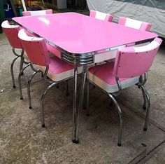 a pink and white table with six chairs