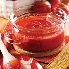 a bowl of tomato sauce on a wooden table