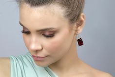 Make a statement with these gorgeous Rectangular Garnet Gold Dangle Earrings. Measuring 13x18mm, these earrings feature prong-set semiprecious garnet stones, making them a perfect accessory to celebrate your January birthstone. The gold finish adds a touch of luxury, making these earrings a great choice for special occasions. These handmade earrings are crafted with high-quality materials and are sure to last for years to come. January birthstone garnet earrings Prong set semiprecious stones Han Sterling Silver Earrings Handmade, Garnet And Gold, Rectangle Earrings, January Birthstone, Garnet Earrings, Garnet Stone, Red Earrings, 925 Silver Earrings, Garnet Gemstone