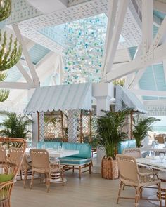 an indoor dining area with tables and chairs