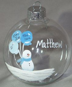 a glass ornament with a snowman and balloons on it that says mother