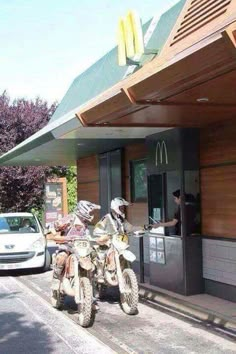 two motorcycles parked in front of a mcdonald's