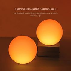 two round lights sitting on top of a wooden block next to an orange background with the words sunrise simulator alarm clock