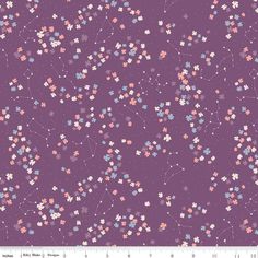 a purple background with small pink and blue flowers on the left side, and stars in the middle