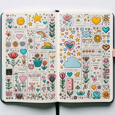 an open notebook with stickers on the pages and colorful flowers, hearts, stars