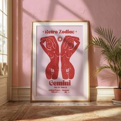 a red poster hangs on the wall next to a potted plant in front of a window