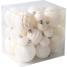 a clear box filled with lots of white ornaments