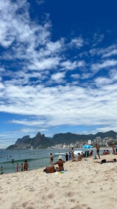 many people are on the beach and in the water