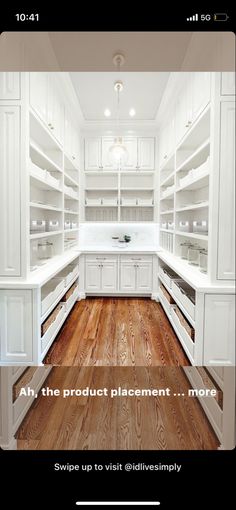 an image of a kitchen with white cabinets and wood flooring on the phone screen