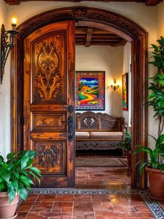 an ornate wooden door leading to a living room with potted plants on the floor