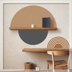 a table and chair in front of a wall with a circular design on the wall