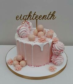 a pink cake with white icing and flowers on top that says eighttienth