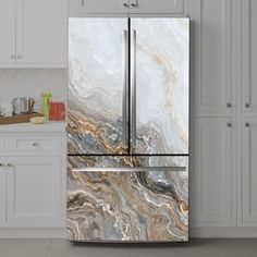 a marble refrigerator freezer sitting in a kitchen next to white cabinets and counter tops