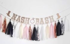 a party banner with tassels hanging from it's sides and the words mash bash on it