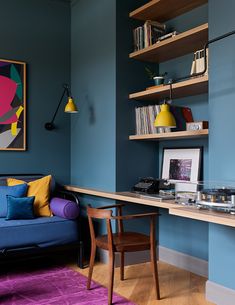 a living room with blue walls and purple rug