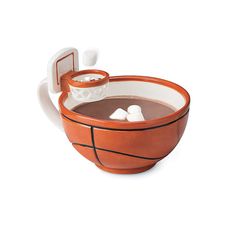 an orange and white basketball shaped cup with ice cubes in the bottom, on a white background