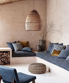 a living room filled with lots of furniture next to a fire place and potted plant