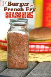 a mason jar filled with french fry seasoning sitting on top of a wooden table