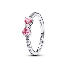 Meet the Sparkling Pink Bow Ring: an elegant piece crafted from sterling silver. This versatile ring features two prong-set heart-cut fancy pink cubic zirconia stones as the centrepiece, with a delicate bow motif symbolizing light and festivity. The band is adorned with 14 bead-set round brilliant-cut clear cubic zirconia for added sparkle. Perfect for pairing with both casual and formal outfits, this ring adds a touch of colour to any look. Things For Wishlist, Pandora Bow Ring, Coquette Rings, Cute Silver Jewelry, Cute Girly Stuff, Xoxo Jewelry, Pandora Pink, Pandora Ring, Wishlist Ideas