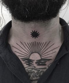 a man with a neck tattoo that has the sun and water on it's chest