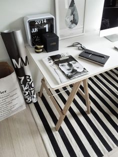 a white desk with black and white accessories on it