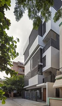 an apartment building with balconies on the second floor