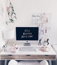 a white desk with a computer on it