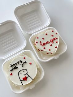 three heart shaped cakes in plastic containers with writing on them that say happy valentine's day