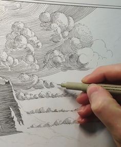 a person is drawing on paper with a pencil