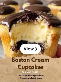 a close up of a person holding a cupcake with chocolate frosting on it