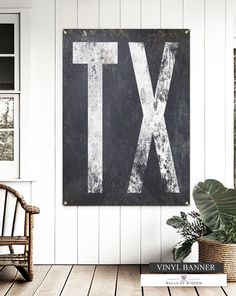 a black and white sign with the letter tx on it next to a chair