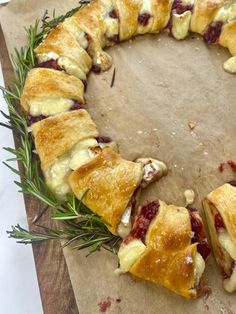 a pastry with cranberry sauce and rosemary sprigs